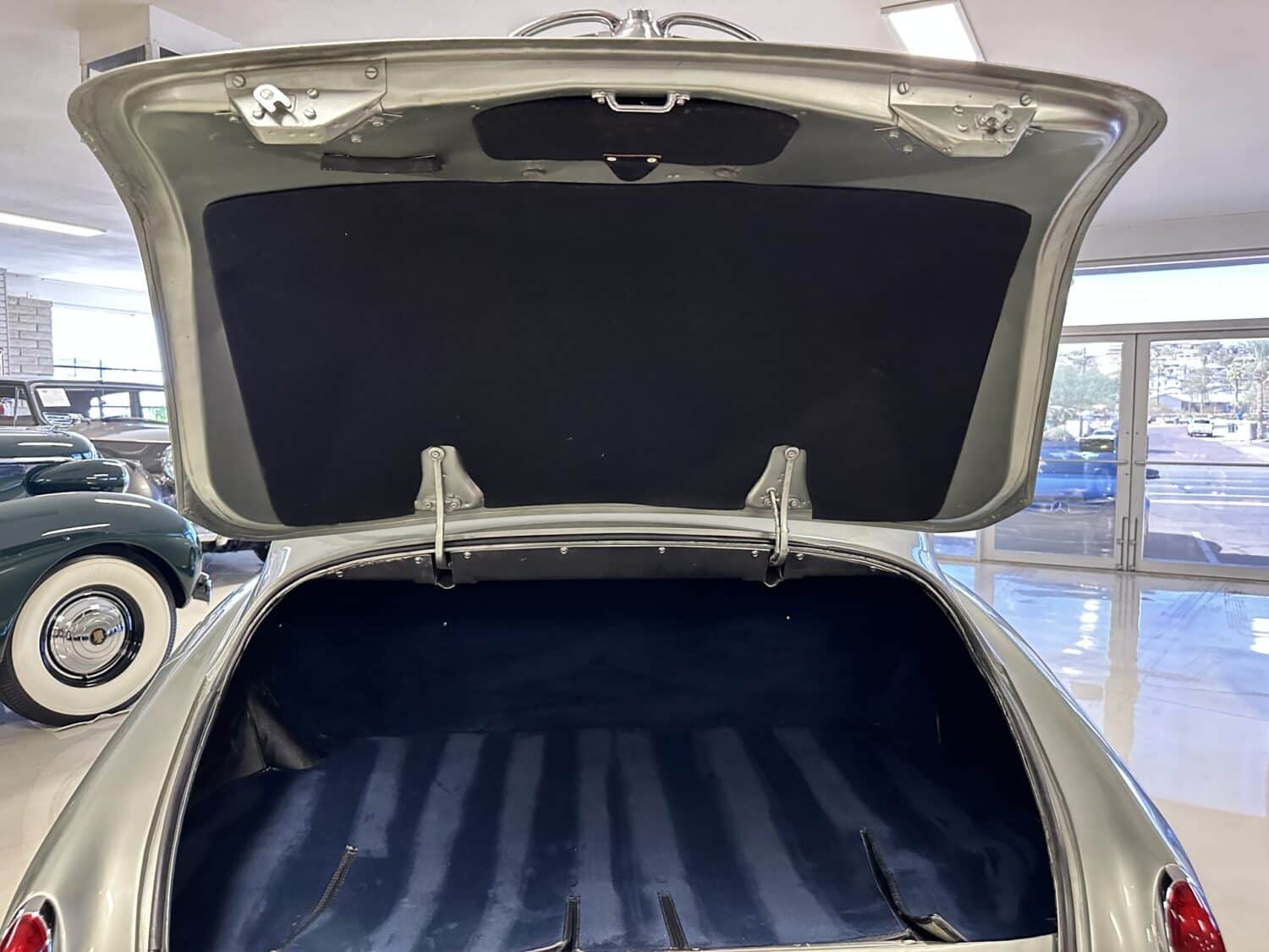 Blue floor in the trunk of the vintage/antique Rolls-Royce for storage and the rear air conditioning is hidden and covered.